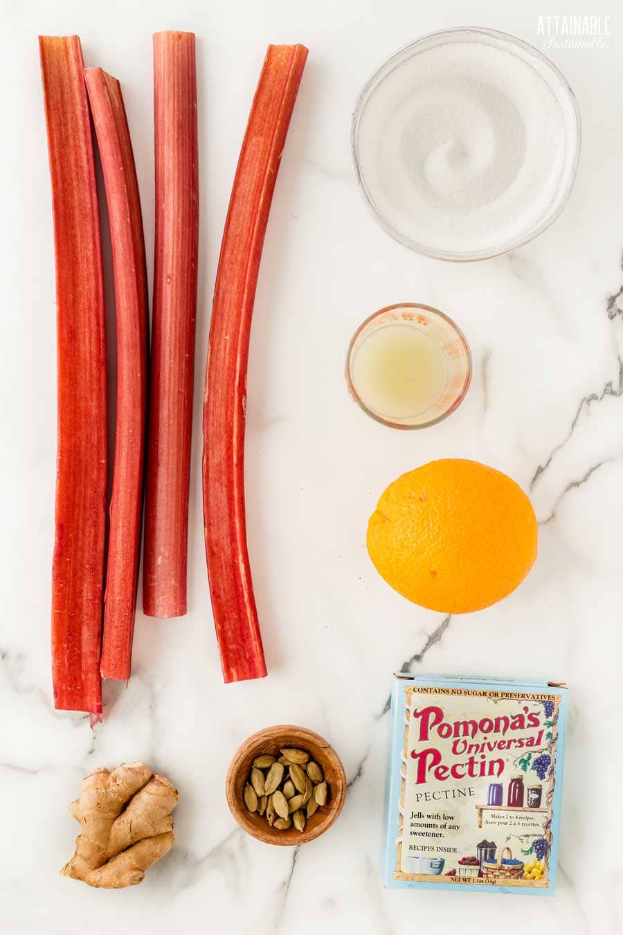 ingredients for rhubarb jam on a marble background.