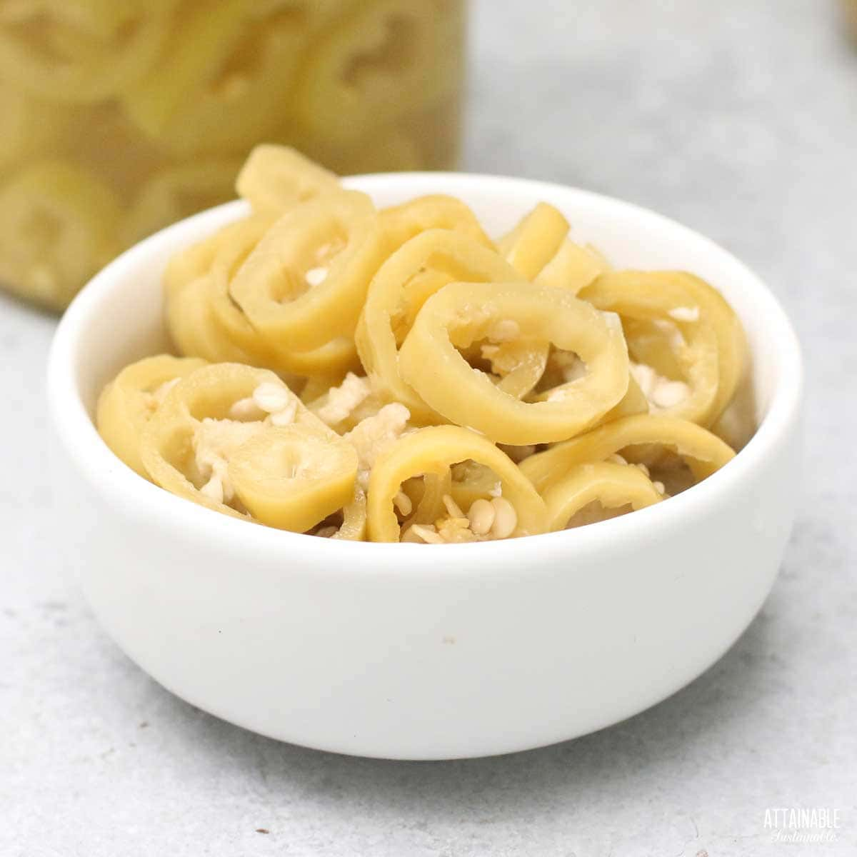 small white bowl of pickled banana pepper rings.