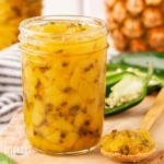 canning jar of pineapple jalapeno jam, lid off.