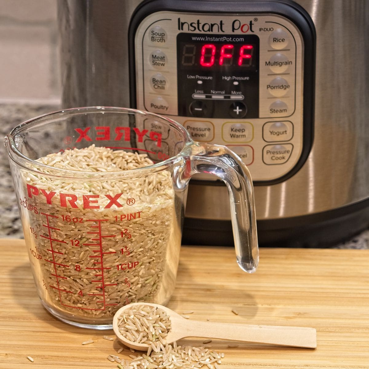 instant pot with a measuring cup full of dry rice.