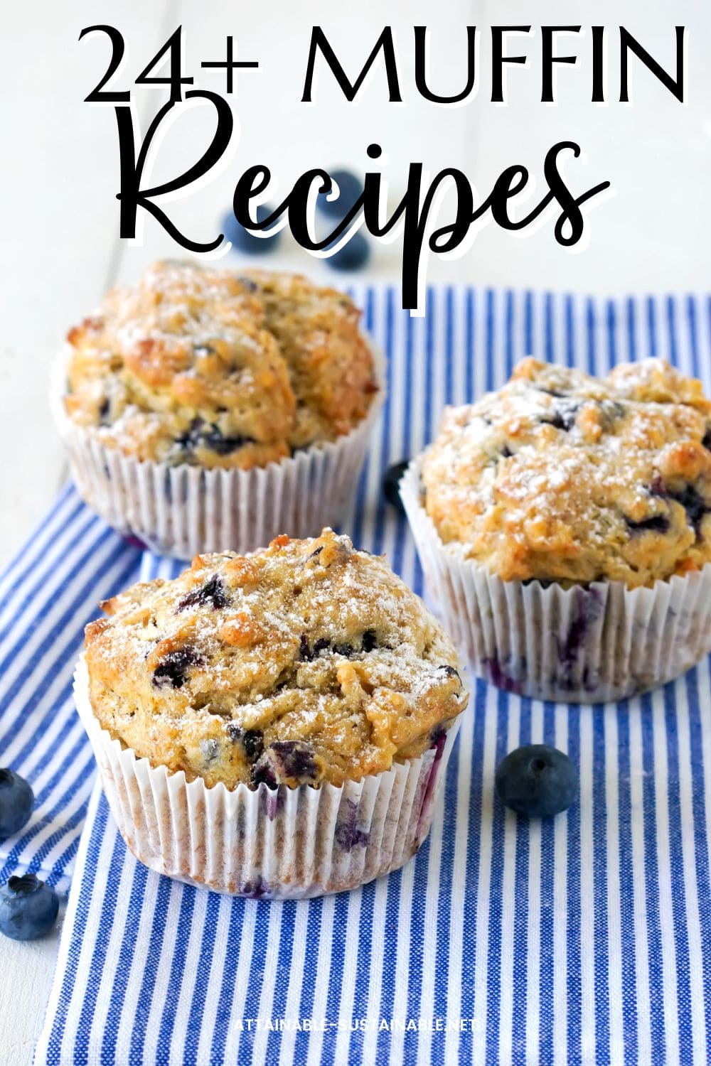 blueberry muffins on a blue and white striped towel.
