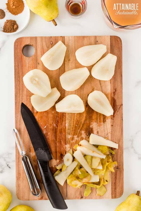 cutting board with peeled and cored pears.