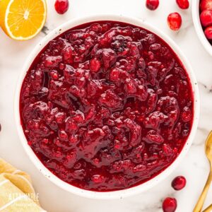 white bowl full of orange cranberry sauce from above.