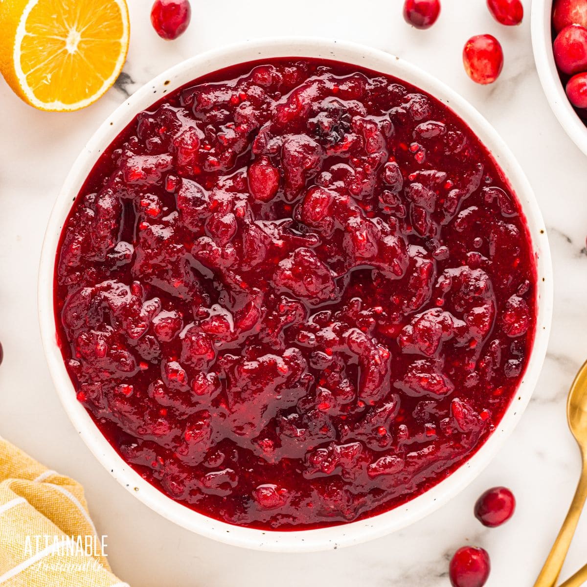 white bowl full of orange cranberry sauce from above.