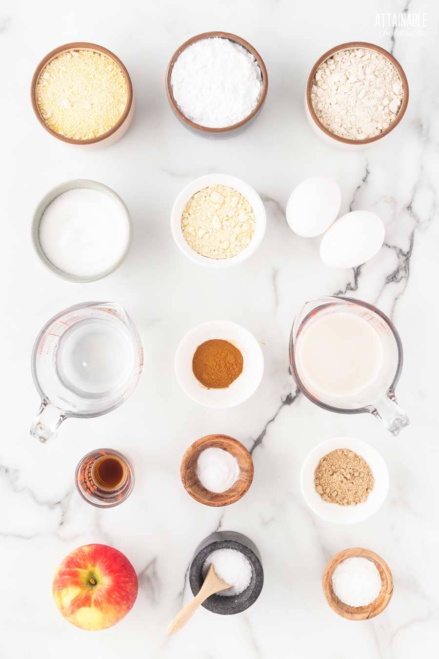 ingredients for gluten free apple muffins on a marble background.