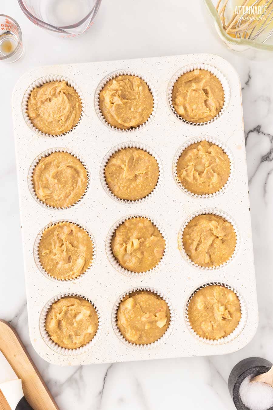 filled muffin cups ready to be baked.