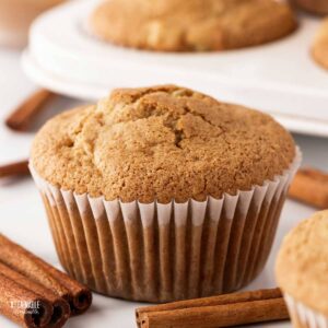 close up of gluten free apple muffin in a paper muffin cup.