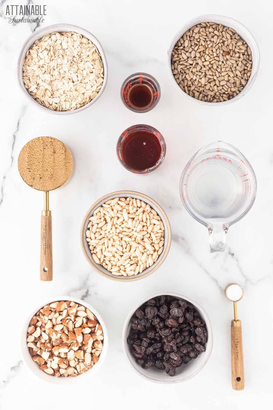 ingredients for making granola from above, on a marble surface.