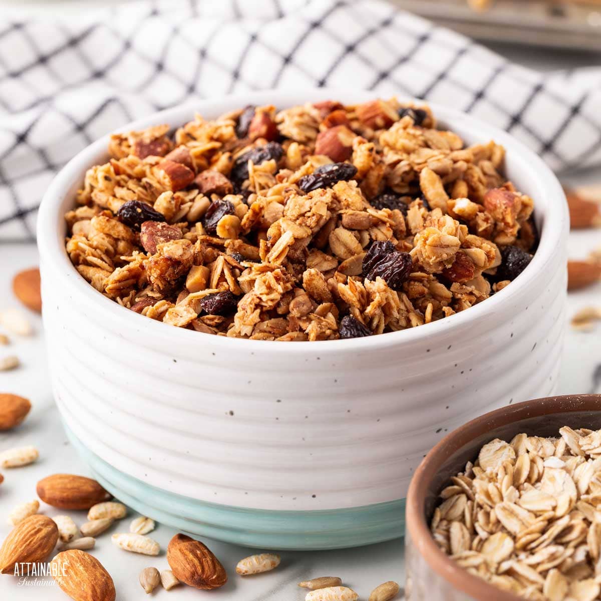 WHITE pottery bowl with a teal band at the bottom, full of homemade granola.