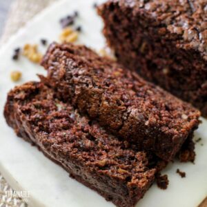 chocolate zucchini bread on white cutting board.