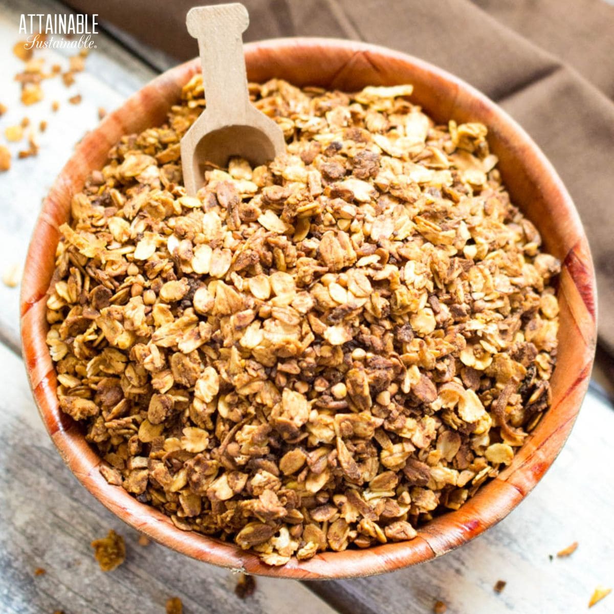 This healthy homemade granola is an easy breakfast food to make at home, plus it will save you bundles of cash. Persimmons give this granola a rich flavor. homemade granola in a wooden bowl.