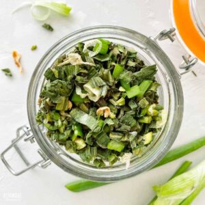 dried green onions in a swing top jar.