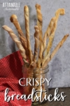 crispy breadsticks standing upright in a glass jar.